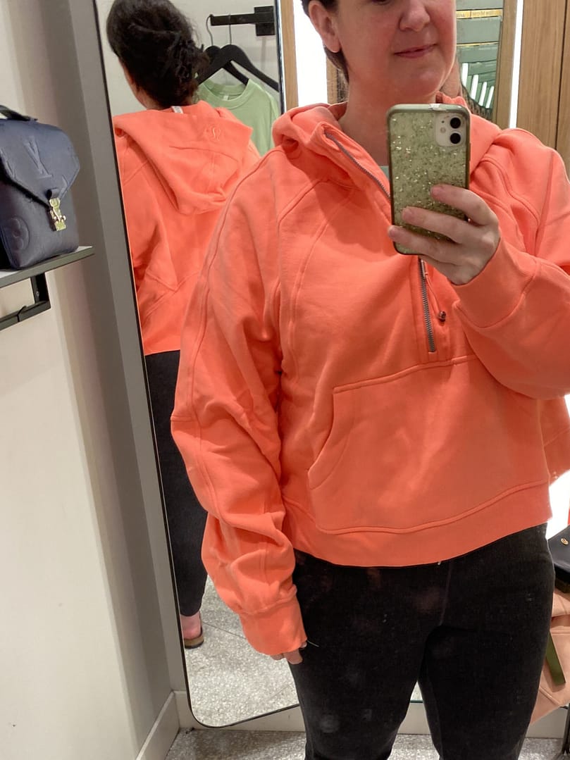 fitting room try-ons of orange jacket