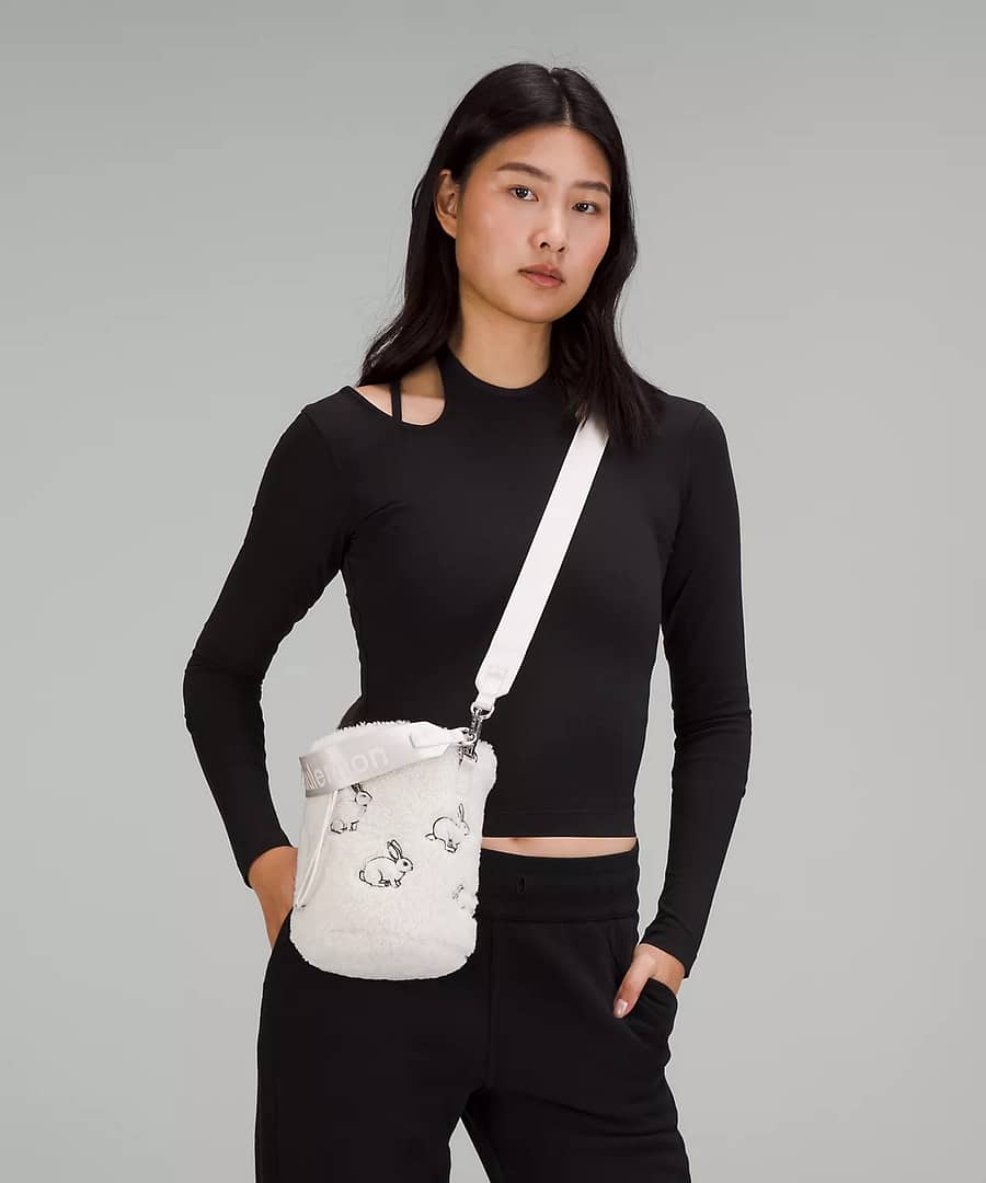 woman using New Year Crossbody Bucket Bag Fleece from lululemon lunar new year collection