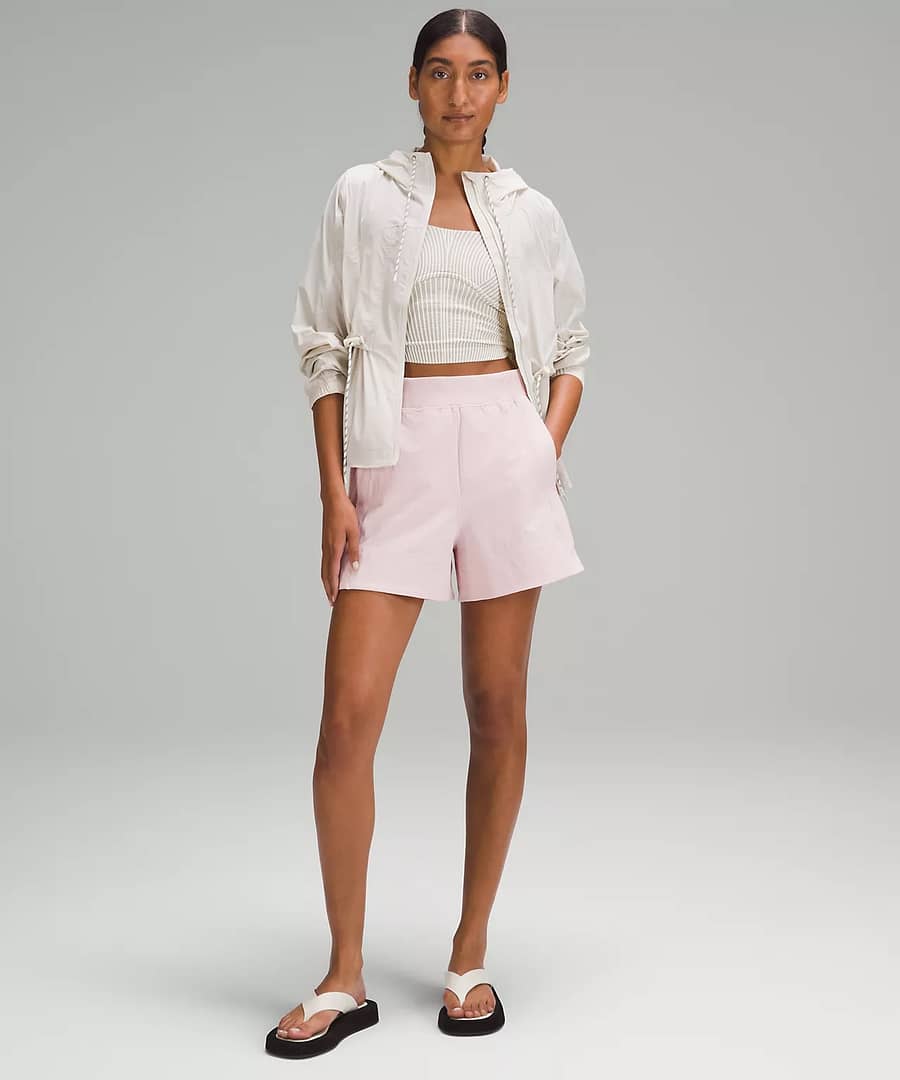 woman wearing lululemon women's shorts - Stretch Woven Relaxed-Fit High-Rise Short 4" - blush pink to pair with lululemon scuba jacket