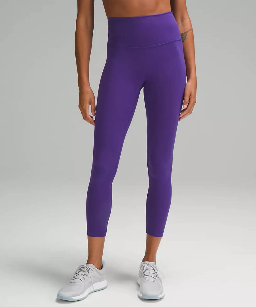 woman Fashionably Fit with Lululemon wearing Wunder Train High-Rise Tight 25" petrol purple